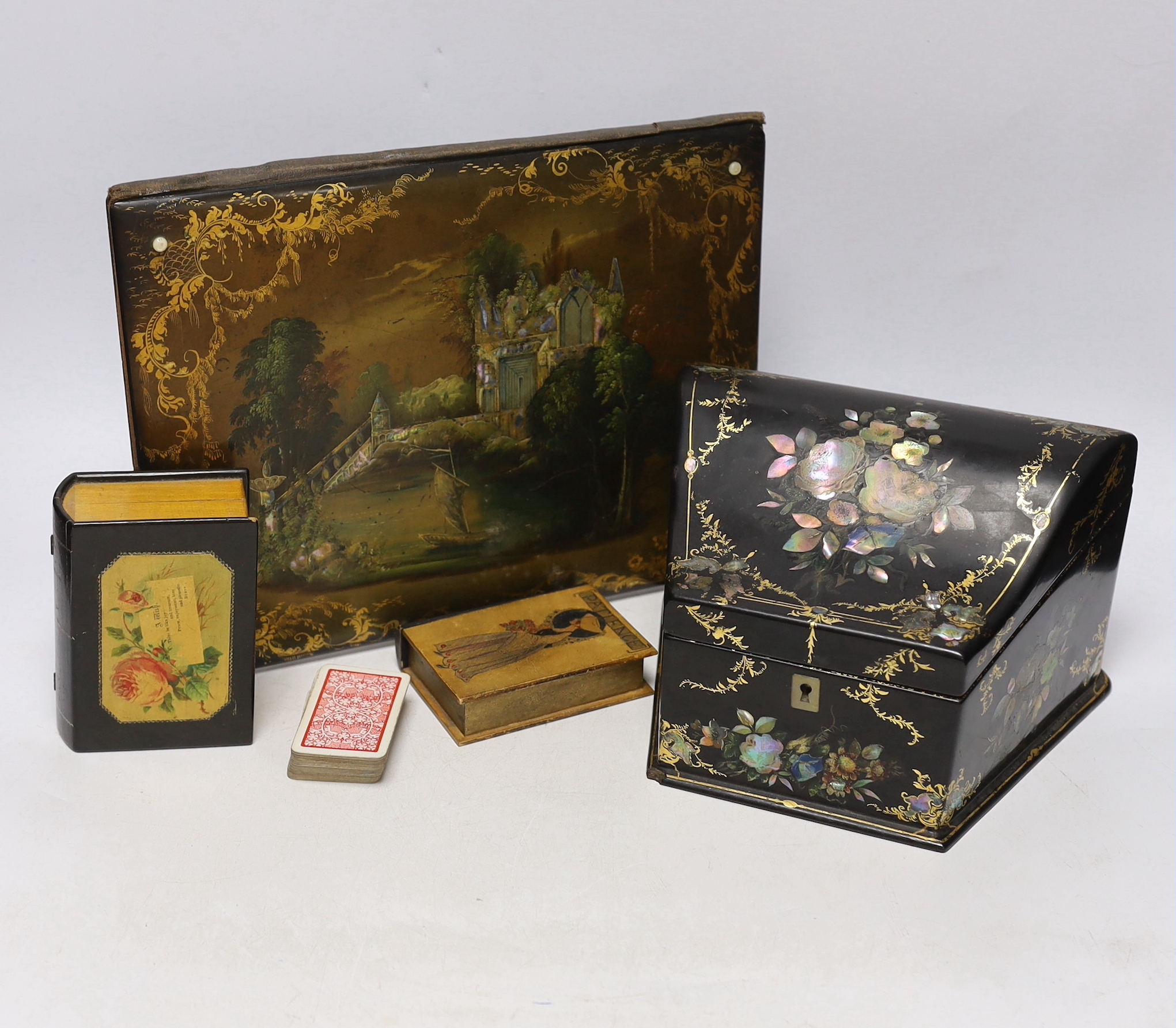 A Victorian papier maché blotter pad, and stationery box and two ebonised treen boxes